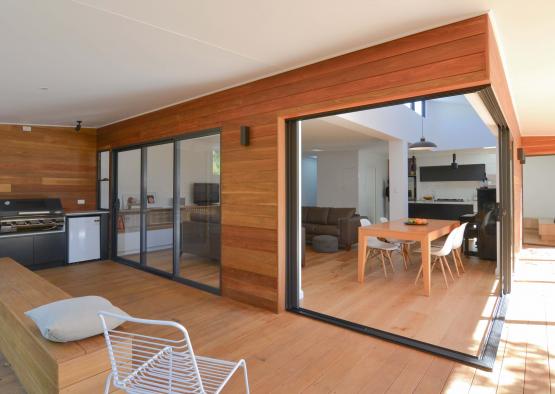 a room with a dining table and a kitchen