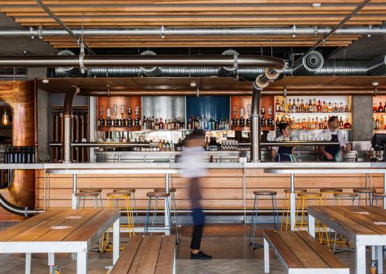 a bar with wooden benches and tables