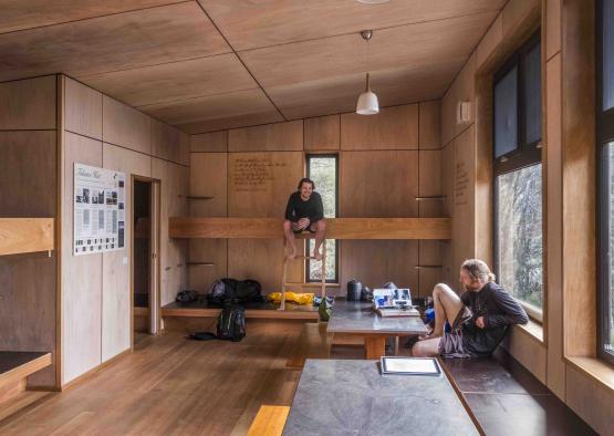 a man sitting on a ledge in a room with a window