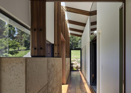 a hallway with a wood beam and a stone wall