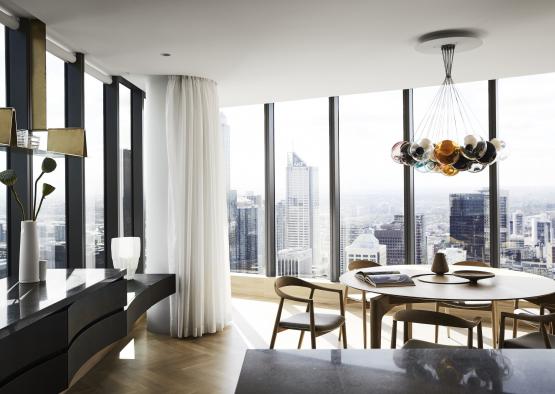 a room with a table and chairs and a chandelier