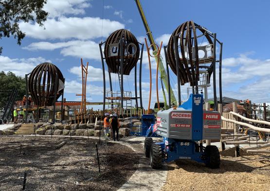 a construction site with a crane and a large round object