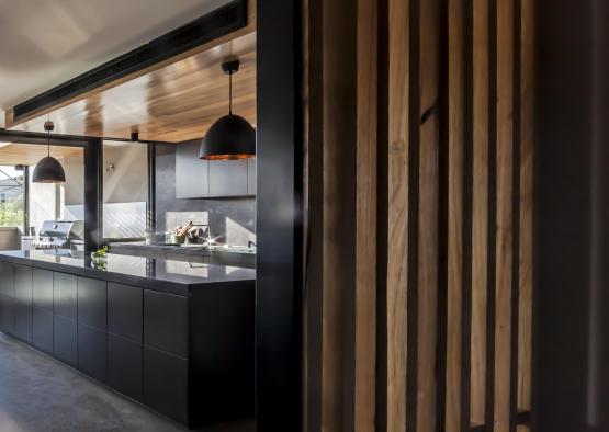 a kitchen with a wood wall and ceiling