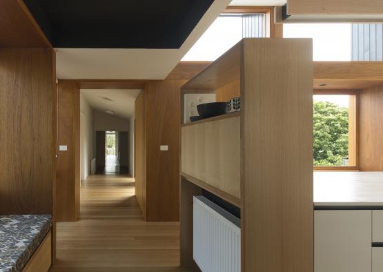 a hallway with a wood shelf and a wood floor