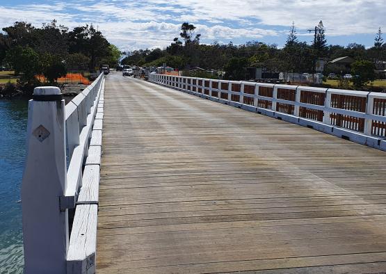 a wooden bridge with a white railing