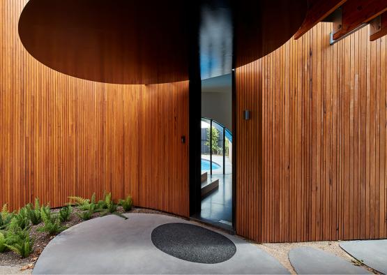 a wood wall with a circular doorway