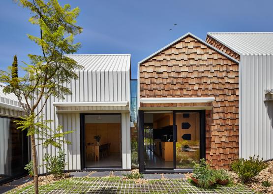 a building with a green yard and a tree