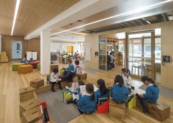 a group of children sitting in a classroom