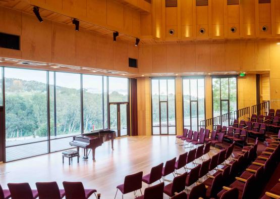 a room with a piano and chairs