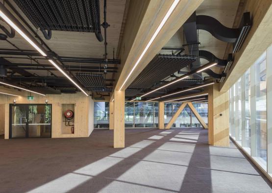 a large room with wooden pillars and a window