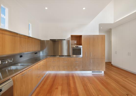 a kitchen with wood cabinets and stainless steel appliances