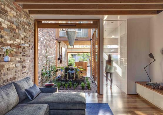 a living room with a brick wall and a couch