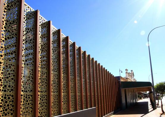 a building with a wall and a street light