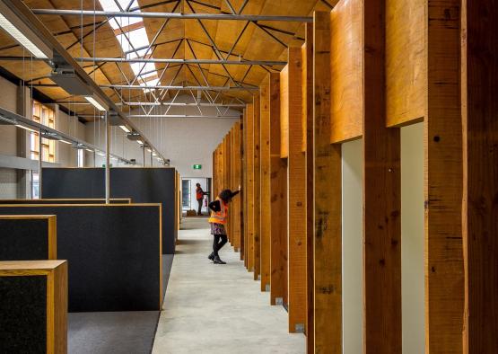 a person standing in a room with wood walls