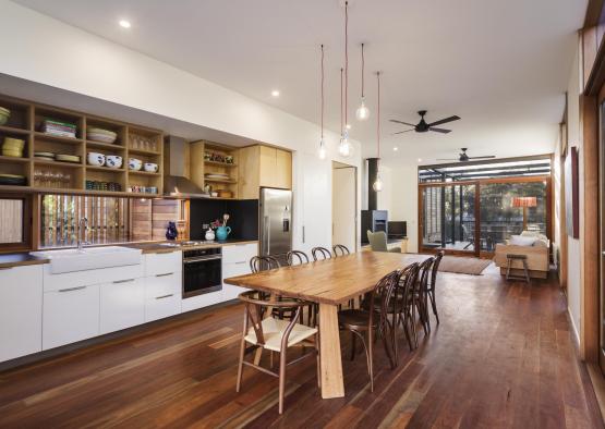 a dining table and kitchen with wood floors