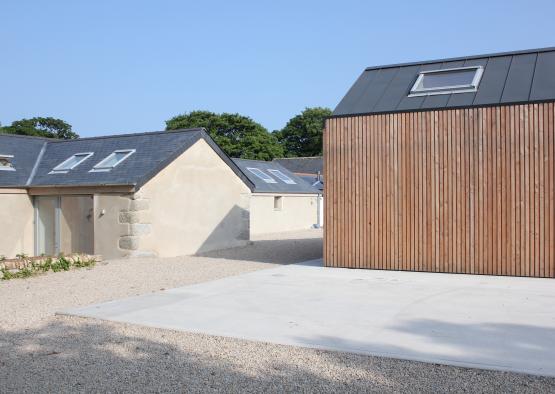 a wooden shed next to a garage