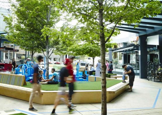 people walking around a playground