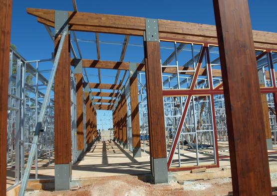 a building under construction with a man standing in front of him