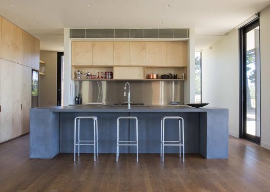 a kitchen with a bar and stools