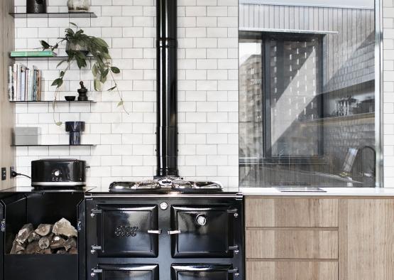 a kitchen with a stove and wood cabinets