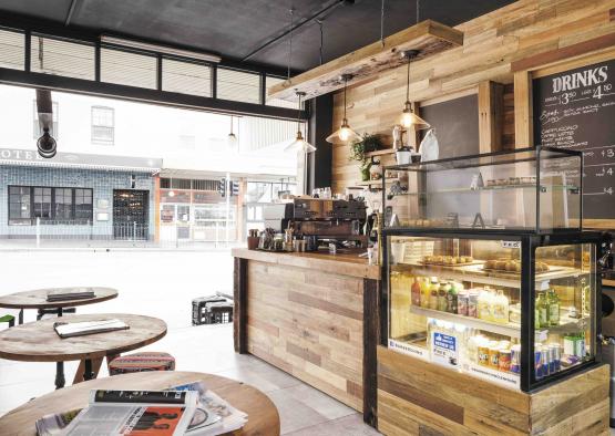 a coffee shop with a counter and a glass case