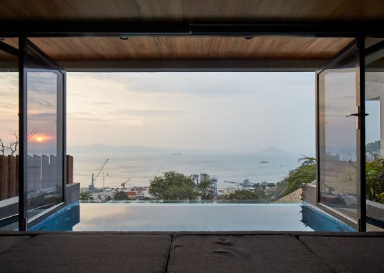 a pool with a view of the ocean and a city