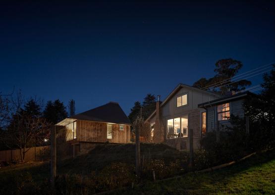 a house with a fence and a fence at night