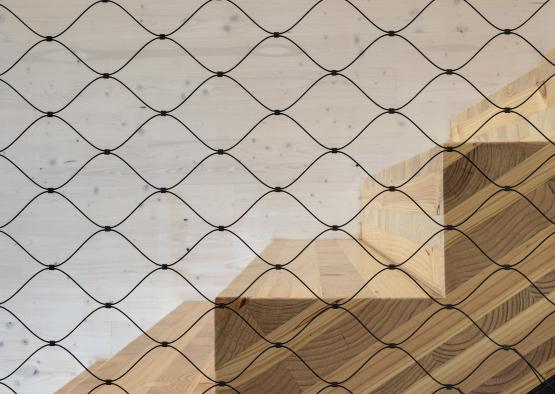 a wooden stairs with a wire fence