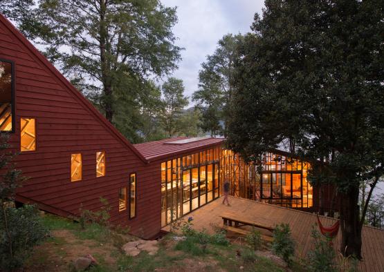 a building with a wood deck and a wooden bench