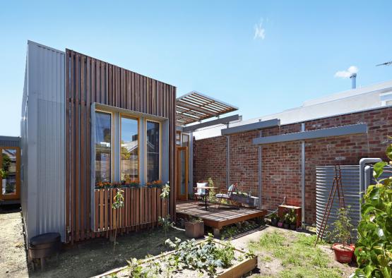 a brick building with a patio and plants