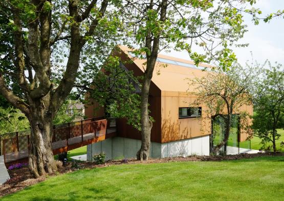 a building with a bridge and trees