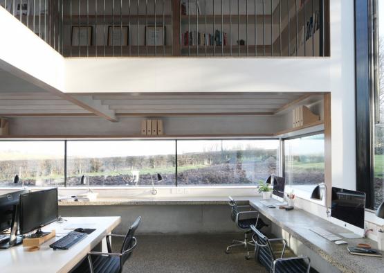 a room with two computers and a staircase