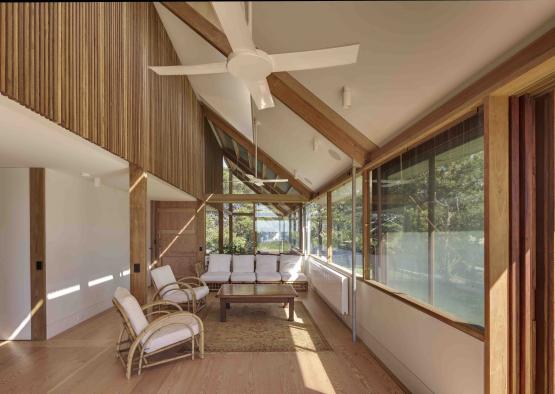 a room with a ceiling fan and a couch and a coffee table