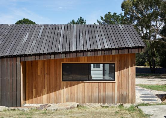 a small wooden building with a window