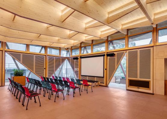 a room with chairs and a projector screen