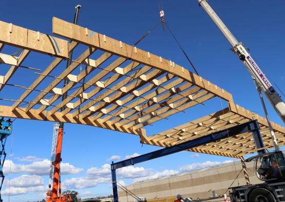 a construction site with cranes and a wooden structure