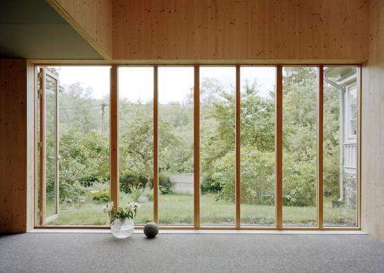 a room with glass doors and trees outside