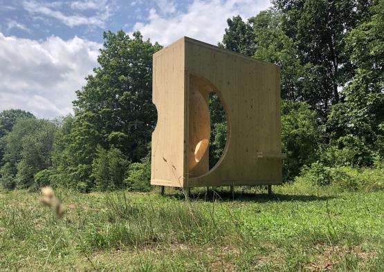 a wooden box in a grassy area