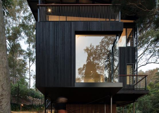 a house with a person walking in the woods