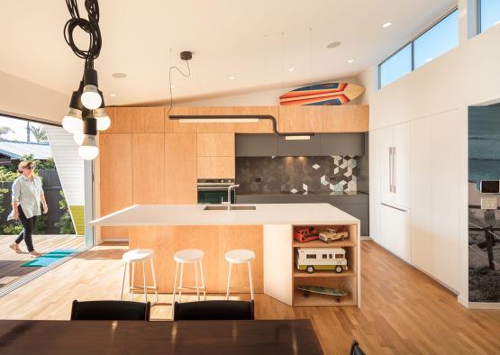 a kitchen with a bar and stools