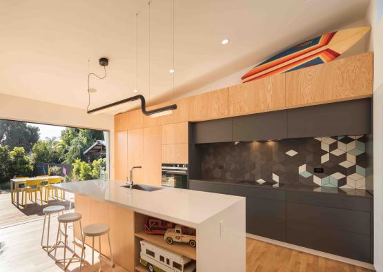 a kitchen with a bar and stools