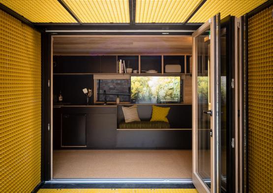 a room with yellow tile walls and a glass door