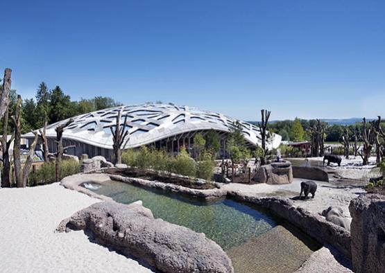 a building with a dome roof and water pools