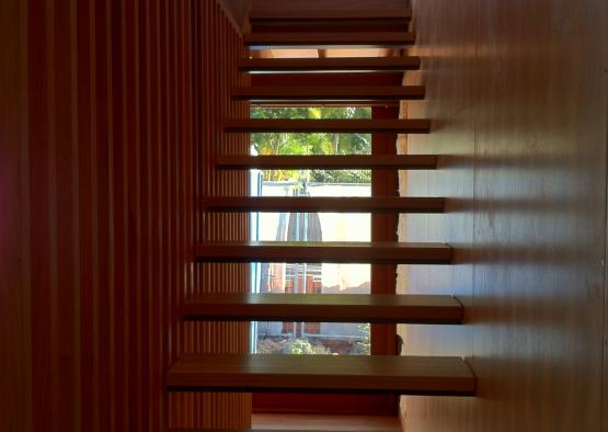 a wooden staircase with a window and a door