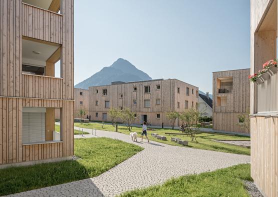 a group of buildings with grass and trees