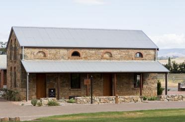 a stone building with a metal roof