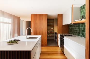 a kitchen with white cabinets and a sink