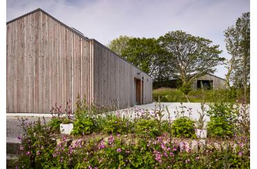 a building with a garden and trees