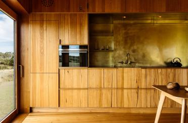 a kitchen with wood cabinets and a table