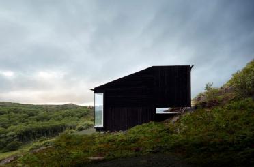 a black building on a hill